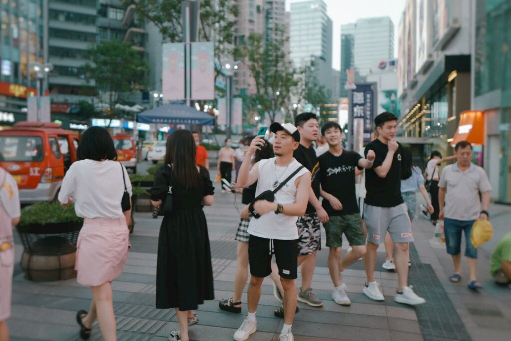woman in black sleeveless dress standing on gray concrete floor during daytime